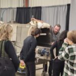 Picture of attendees watching a demonstration of how to use a vegetable washing station at IHSFC